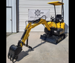FF Industrial FF15 mini excavator: yellow open-canopy machine, boom extended with the digging bucket, backfill blade, tracks