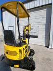 Yellow AGT QH12R mini excavator: canopy, seat, joystick controls and vented engine cover over the tracks