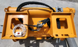 Yellow Landhonor concrete mixer, top view: hydraulic valve block, hoses and corded electric control switch