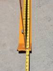 Wolverine snow plow blade edge with tape measure for height reference