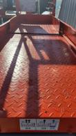Scissor lift platform deck close-up, diamond-plate steel floor
