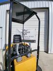 AGT H12R mini excavator seat under the black canopy, with joysticks, track levers and red kill switch