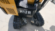 H12R decal on the AGT mini excavator counterweight, with both track drive motors and hydraulic lines