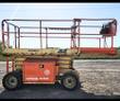 JLG 260MRT rough terrain scissor lift, orange and tan, lowered platform with slide-out deck extension and guardrails