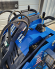 AGT MX-MRW14 controls: twin hand levers on the blue console with hydraulic hoses and an LED work light