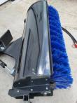 Angle broom from above: black hood over the blue bristle roller with the angle cylinder at the mount