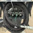 Three-spool electric solenoid valve bank and coiled hydraulic hoses with flat-face couplers on the grading blade