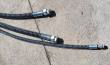 Three spiral-wrapped hydraulic hoses with zinc-plated straight fittings laid out