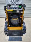 AGT CRT23 mini skid steer from above: 739cc engine, gauge panel with red stop button, rubber tracks and fold-down platform