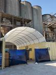 White PVC container shelter arched between two shipping containers on a galvanized steel frame