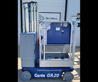 Genie GR-20 vertical mast lift, side view: blue base, gray mast and platform with guardrails