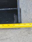 Tape measure across the bucket's cutting edge, reading 40 inches at the side plate