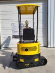 AGT QH12R vented engine housing, canopy and seat above the rubber tracks and backfill blade