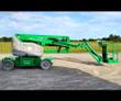 Green Genie articulating boom lift, gray turret, boom lowered and stretched out level with the platform near the ground