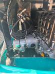 Hydraulic pump and hose fittings inside the KT13R mini excavator's engine compartment