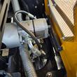 Hydraulic pump and hose fittings mounted inside the MX20R's engine compartment