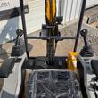 View from the MX20R operator seat: dual joysticks, foot pedals, and wire-braided hydraulic hoses