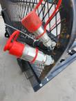 Two hydraulic quick-couplers with red dust caps on the bale processor's mesh backstop