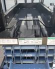 Genie GS-1930 platform deck with its slide-out extension, capacity placards and the scissor stack underneath