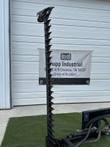 Sickle bar mower's cutter bar raised vertical, black guard teeth along its length, tilt cylinder and hoses at the base