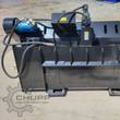 AGT landscape rake from the back: skid steer quick-attach plate, blue hydraulic drive motor, hoses and dump cylinder