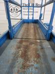 Scissor lift platform floor interior, worn paint, looking down the deck