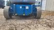 Boom lift rear undercarriage close-up, drive wheels and danger decal