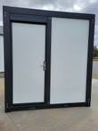 Portable shower restroom exterior, black steel frame with white panels and a locking key-lever door