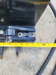 Tape measure along the black sickle mower cutter bar with its pointed guards, reading about 60 inches