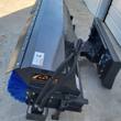 Arteer angle broom from above: steel hood, Arteer decal, hydraulic hoses and skid steer quick-attach plate
