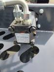 Orbit hydraulic motor on the rock rake frame, nameplate rated 17 MPa, steel lines into the A and B ports