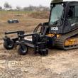 Landhonor soil conditioner mounted on a tracked skid steer, gauge wheels down, working rocky ground