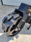 Trench compaction wheel from above: welded steel cleats around the drum and cut-out spoke openings