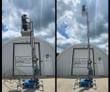 Genie AWP-25S push-around lift with a worker in the platform, mast partly raised and fully extended