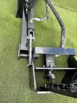 Sickle bar mower's tilt cylinder pinned to the arm, hydraulic drive motor and shaft above the bolted cutter bar