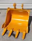 Yellow 24-inch excavator bucket standing open-face, four bolt-on teeth and twin pin-boss ears