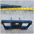 JCT double bale spear: two 42-inch tines on a skid steer quick-attach frame, tape measure laid along one tine