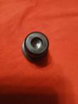 Top view of a black hydraulic filter bypass valve housing showing the round center bore and flange