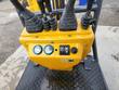 DM12-C controls: two joysticks and travel levers on the yellow console with round gauges, rocker switches and key start