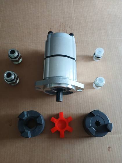 Gear pump with lovejoy coupler hubs, red spider insert and four port fittings laid out