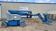 Genie articulating boom lift, side view: boom folded out level, turntable, counterweight and four wheels