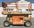 JLG 260MRT rough terrain scissor lift with guardrails up, side engine access panel and four-wheel-drive lug tires