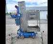 Genie AWP-25S push-around lift: aluminum platform and guardrails on a blue base, telescoping mast and extended outriggers