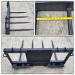 JCT four-spear hay bale spear: black quick-attach frame with four tapered tines, tine spacing measured with a tape