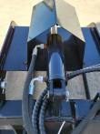 Root grapple clamp cylinder and pivot pin from above, hose elbows on both ports
