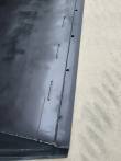 Bucket floor and side wall weld seam, row of bolt slots and holes along the cutting edge