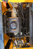 MIVA VA15 engine bay: black fuel tank and filler cap with bundled hydraulic hoses and wiring in the yellow frame
