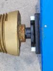 Two hydraulic quick-connect couplers with red dust caps on the log splitter's supply hoses