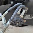 GIYI vibratory roller hydraulic drive motor: bolted flange, spiral-wrapped hoses and steel fittings on the drum frame