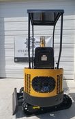 AGT H12R mini excavator from behind: vented yellow engine cowl and counterweight, seat back with AGT plate, canopy